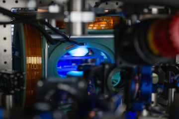 In focus image of a machine with a blue light illuminating the inside.